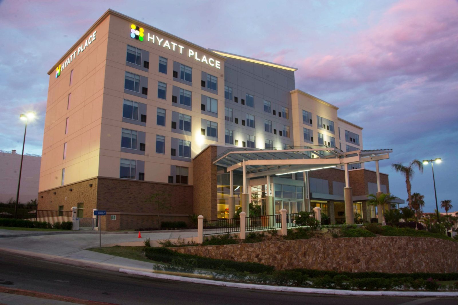 Eye level shot of Hyatt Place Hotel building in San Jose del Cabo at sunset.