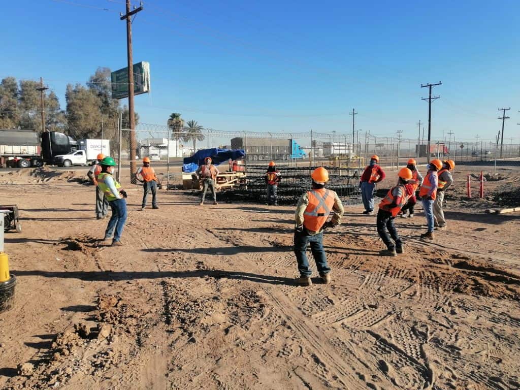Workers doing exercise before starting the construction work. 