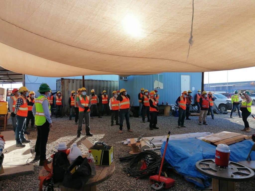 Workers having a meeting before starting construction work.